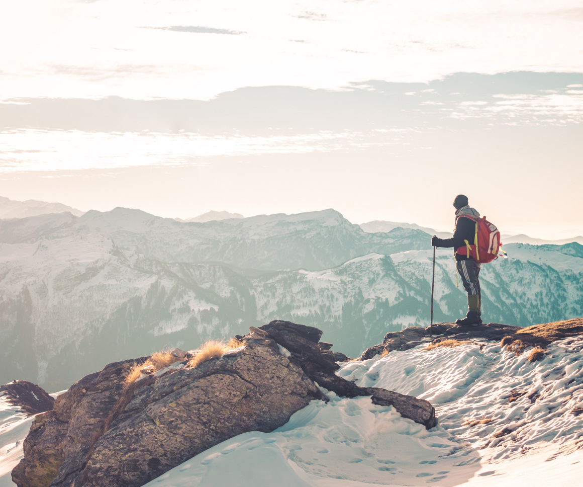 Man overlooking snowy mountains