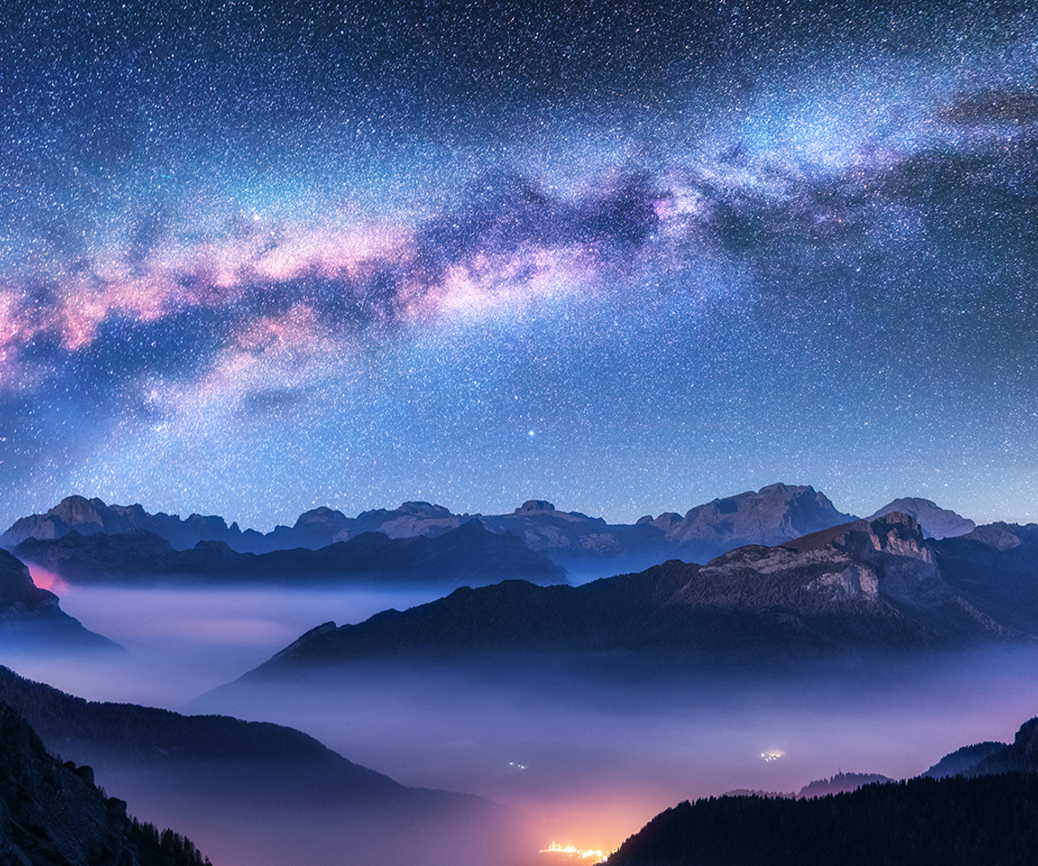 Starry night sky above mountains