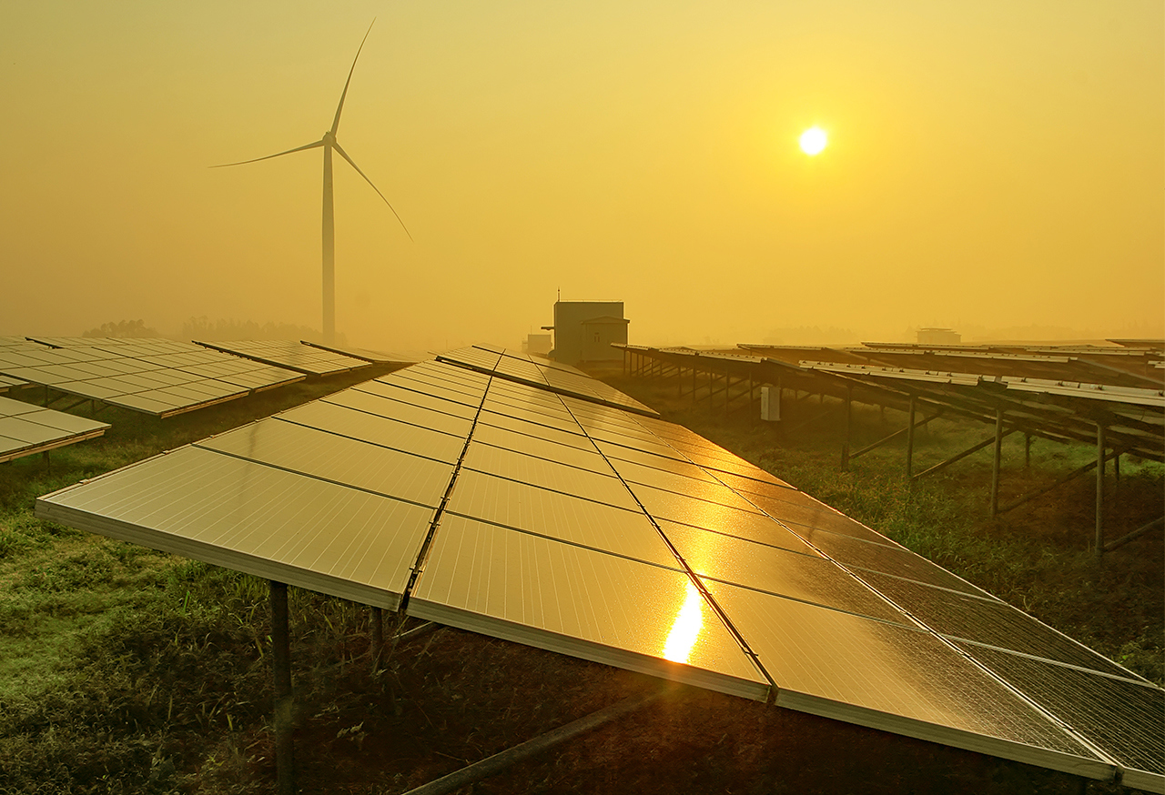 Solar panels and wind turbines in a field