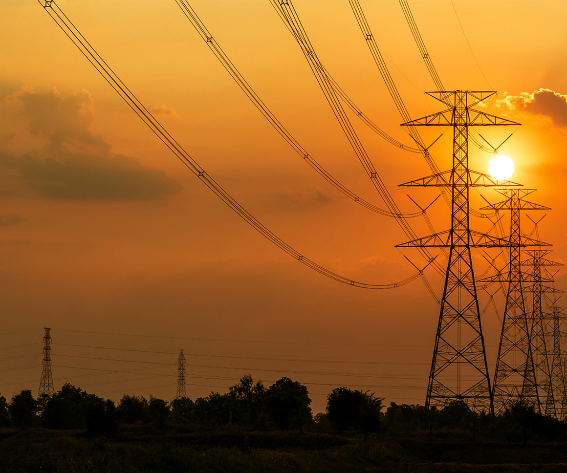 Electricity pylons with the sun