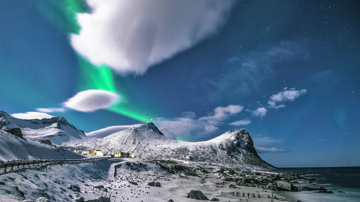 Snowy mountain with Northern Lights in sky