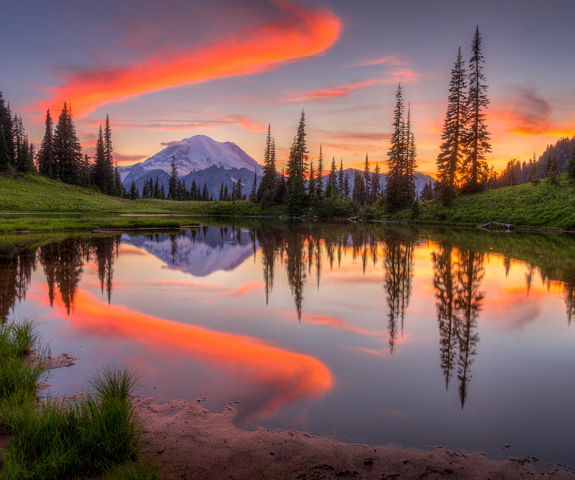 Mountain with orange clouds at sunset
