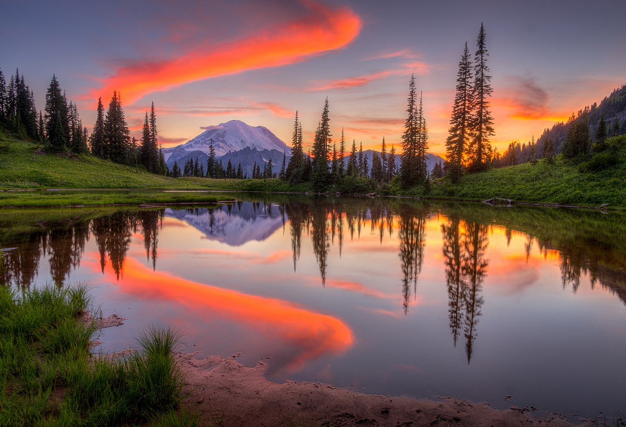 Mountain with orange clouds at sunset