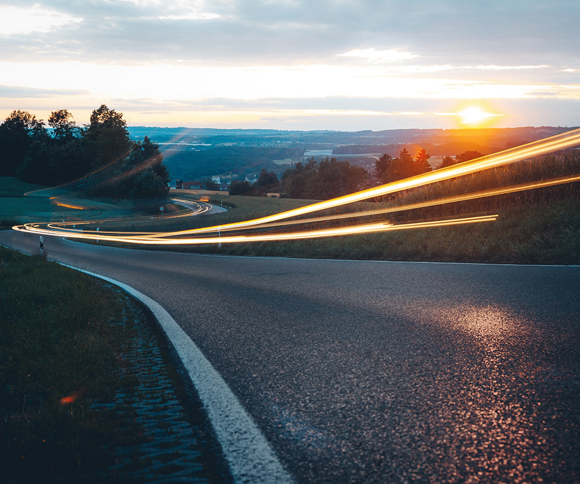 Abstract lights on a road at sunset