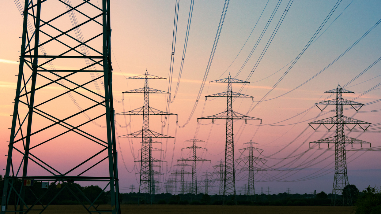 Multiple Transmission Towers Against An Evening Sky