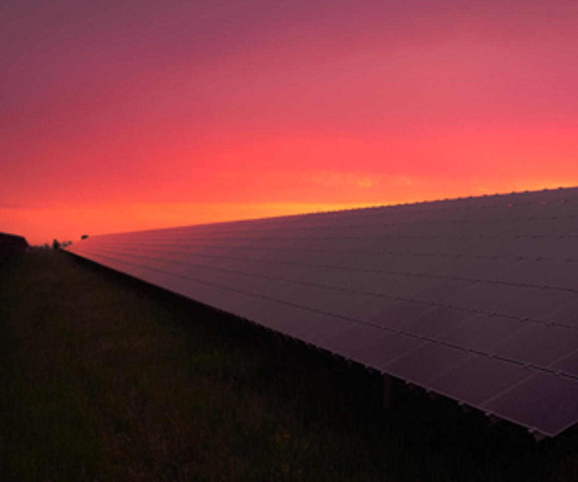 Sunset behind solar panels