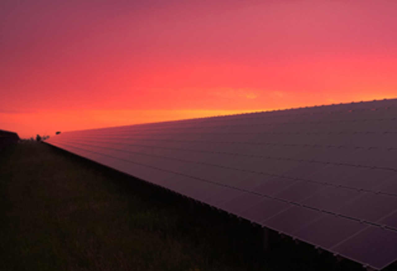 Sunset behind solar panels