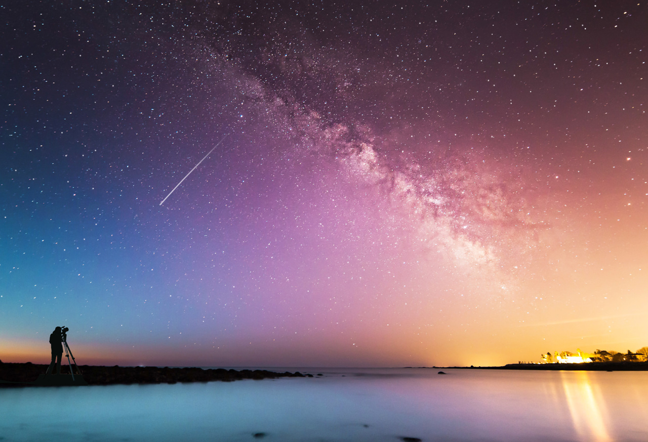 Person looking through telescope at galaxy