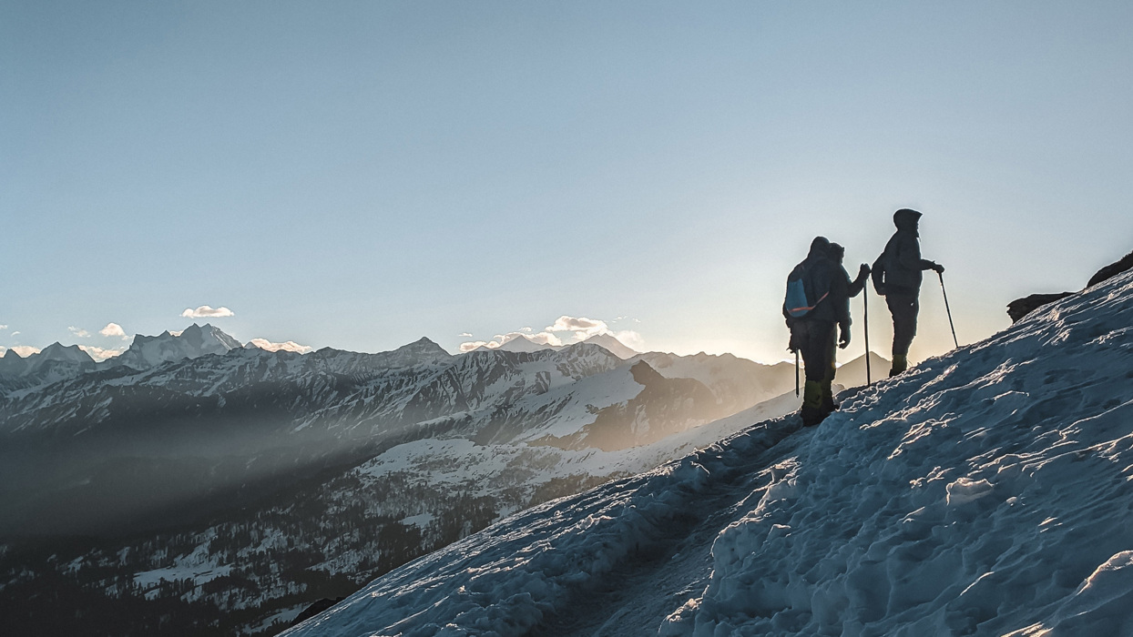 Hikers going up a snowy mountain