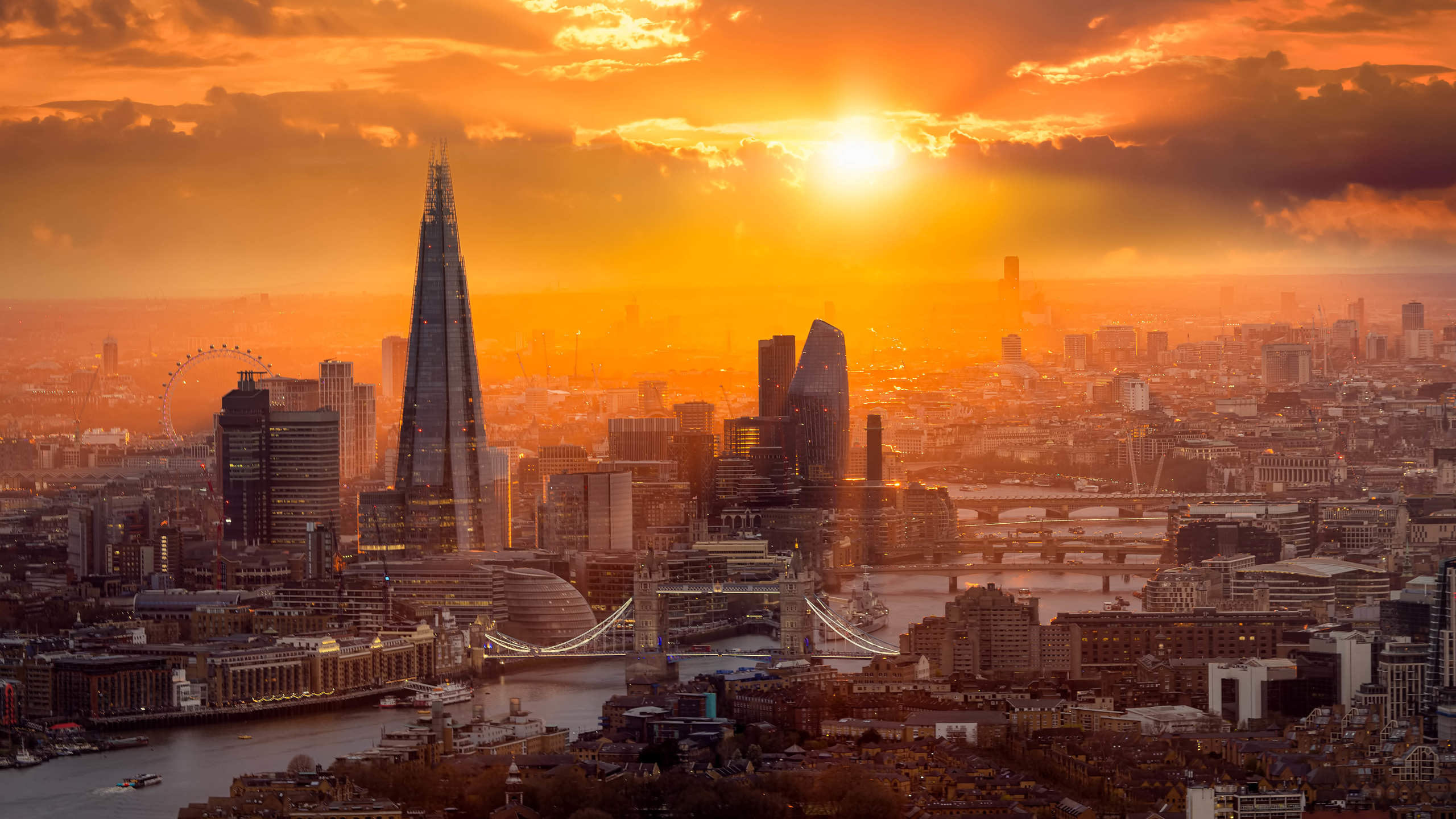 A beautiful sunset behind the London skyline with Tower Bridge, River Thames and the corporate skyscrapers
