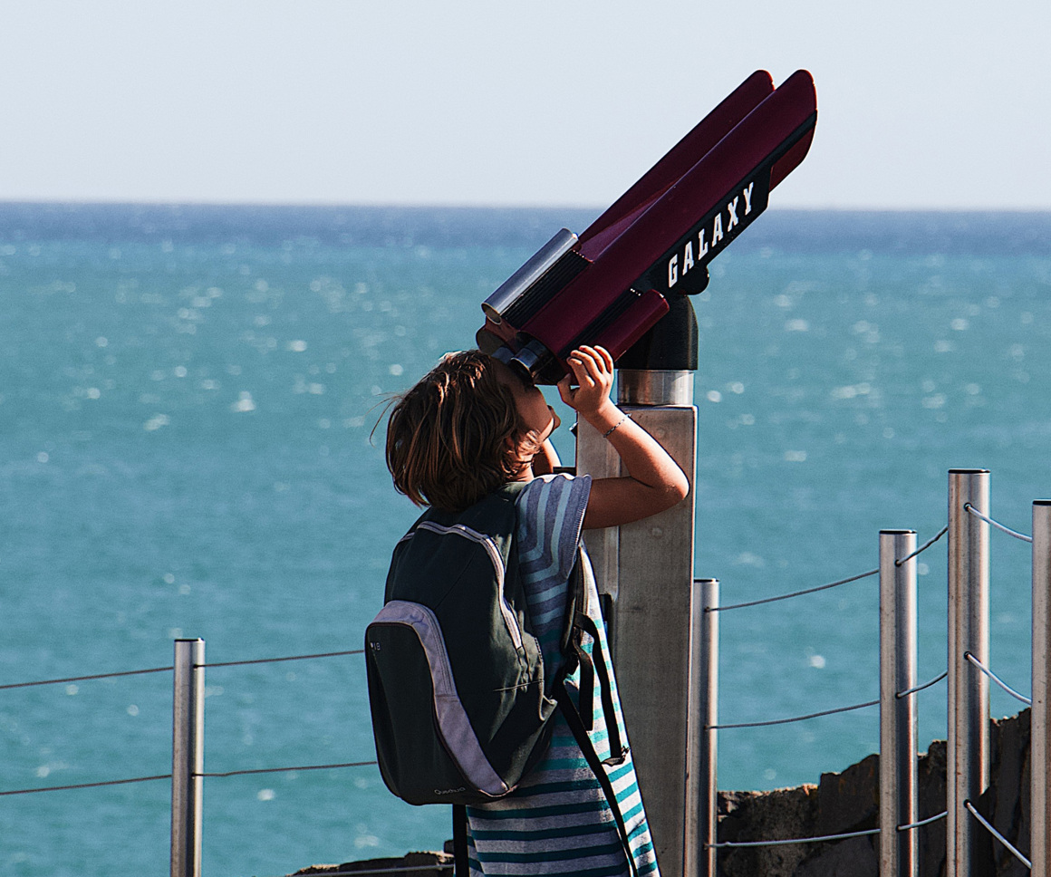 Boy looking through telescope