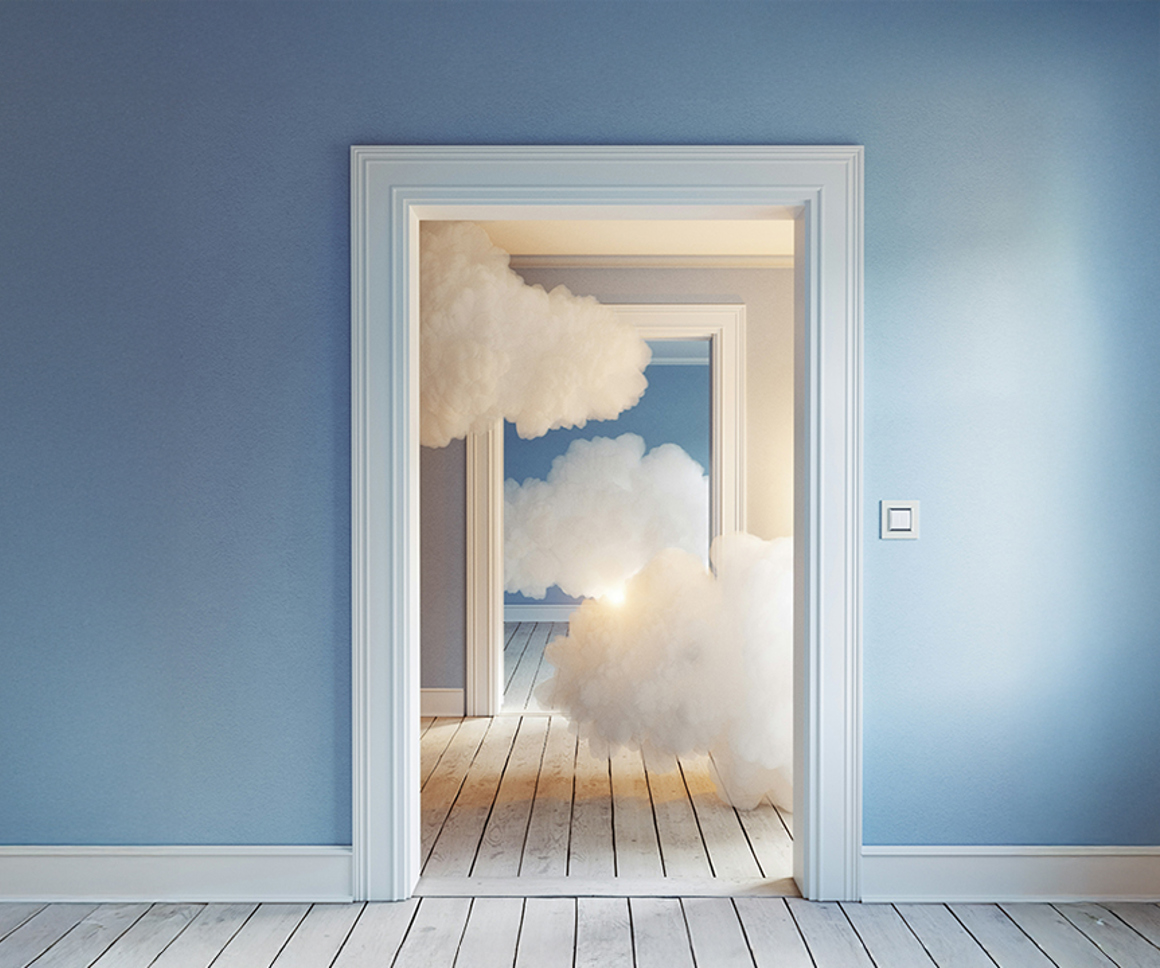 Clouds seen behind doorframes inside a building with light blue walls