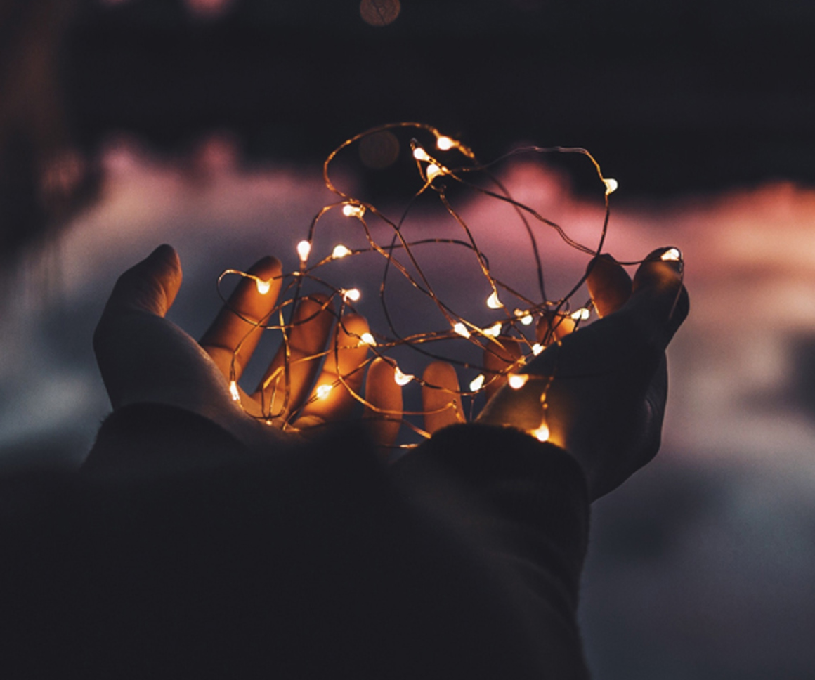 Child's hand holding fairy lights