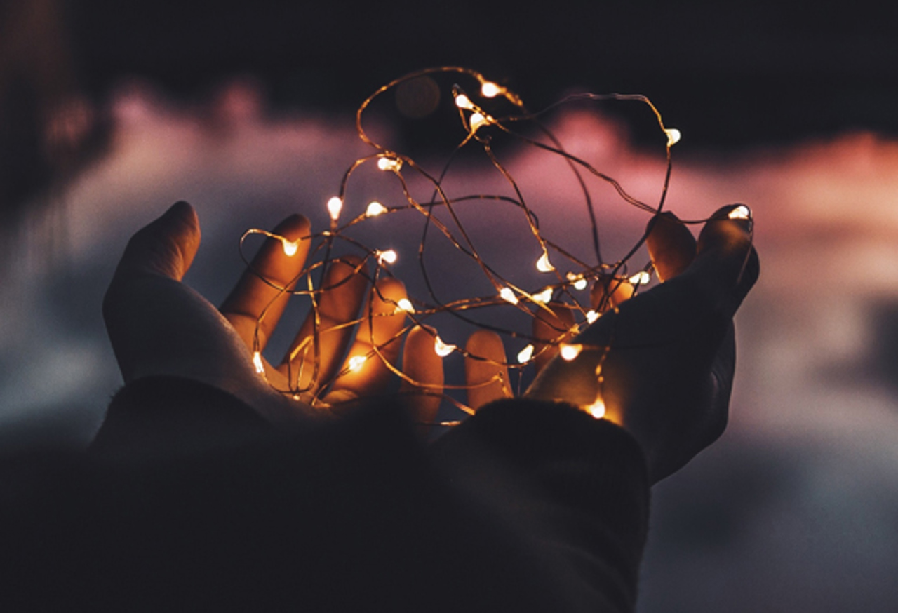 Child's hand holding fairy lights