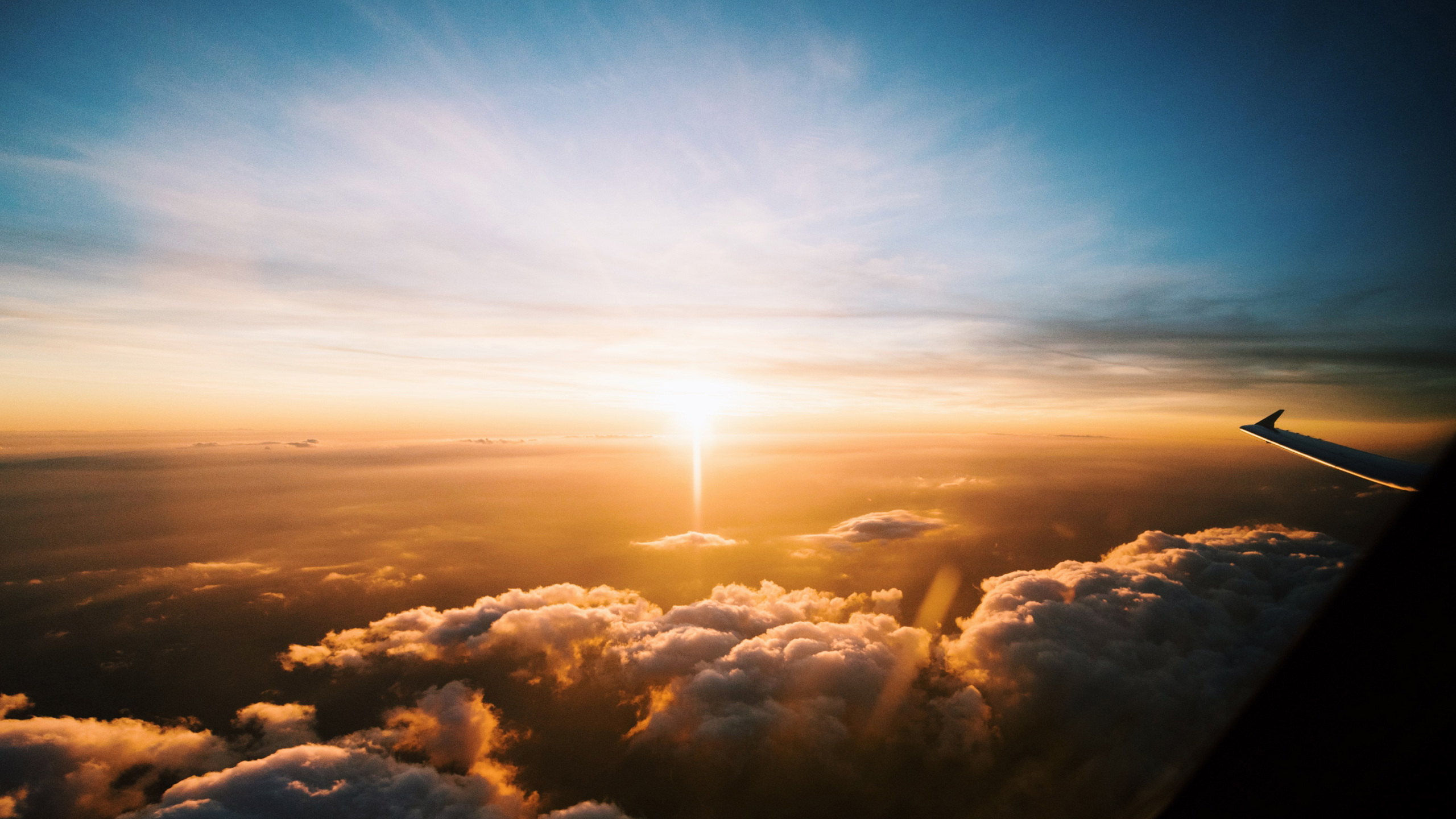 Plane wing above clouds