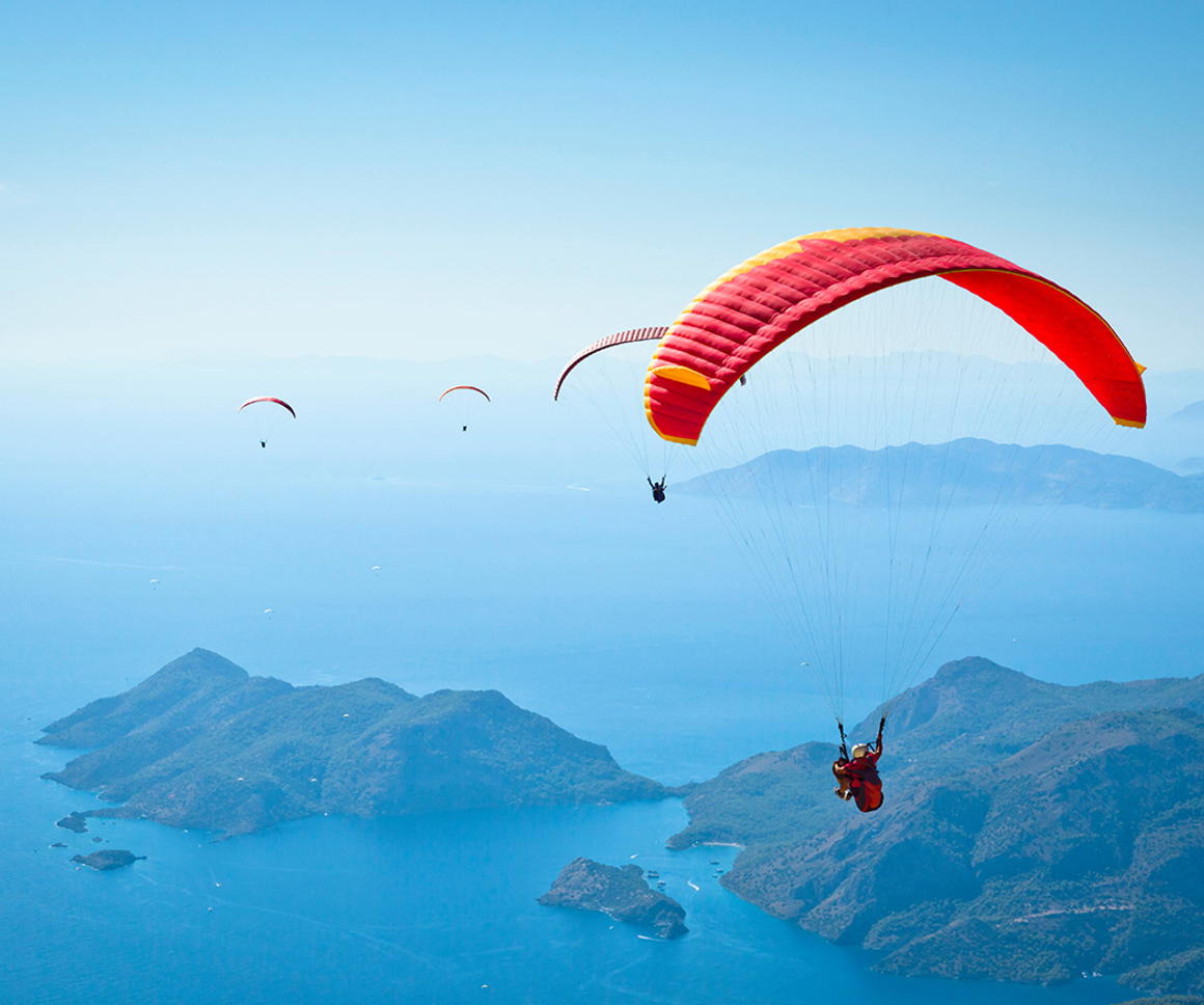Hangliders flying over the sea