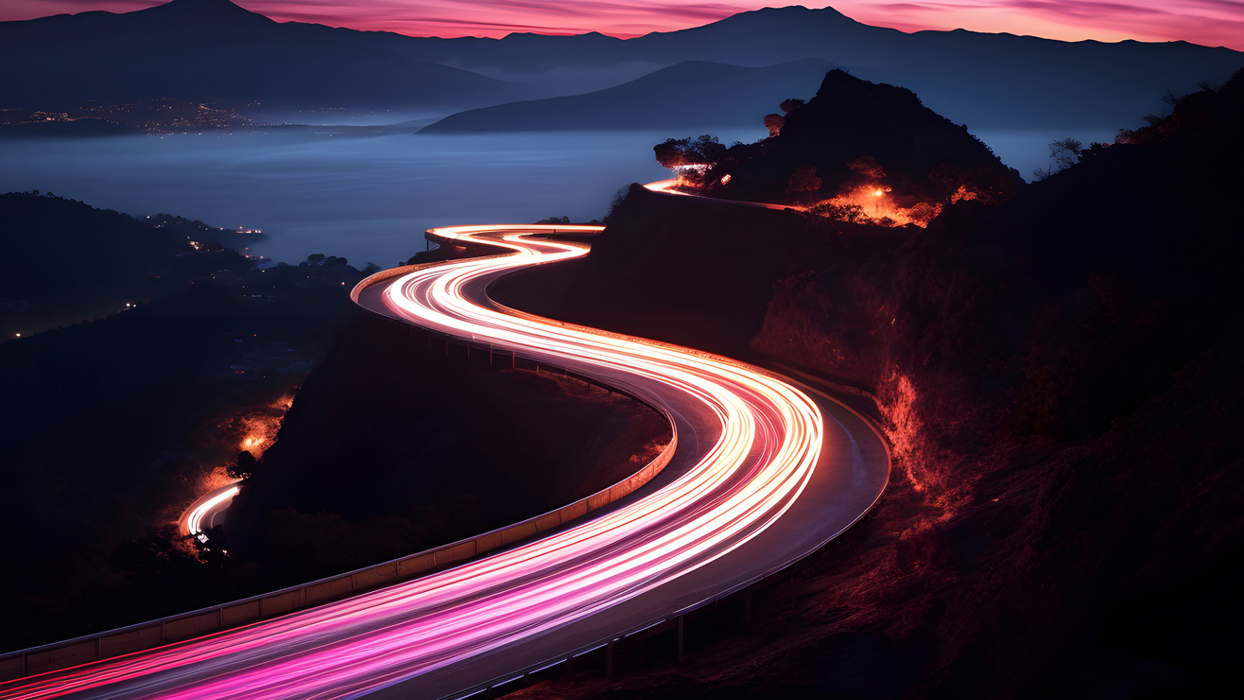 Long exposure lights of cars driving along a snaking road