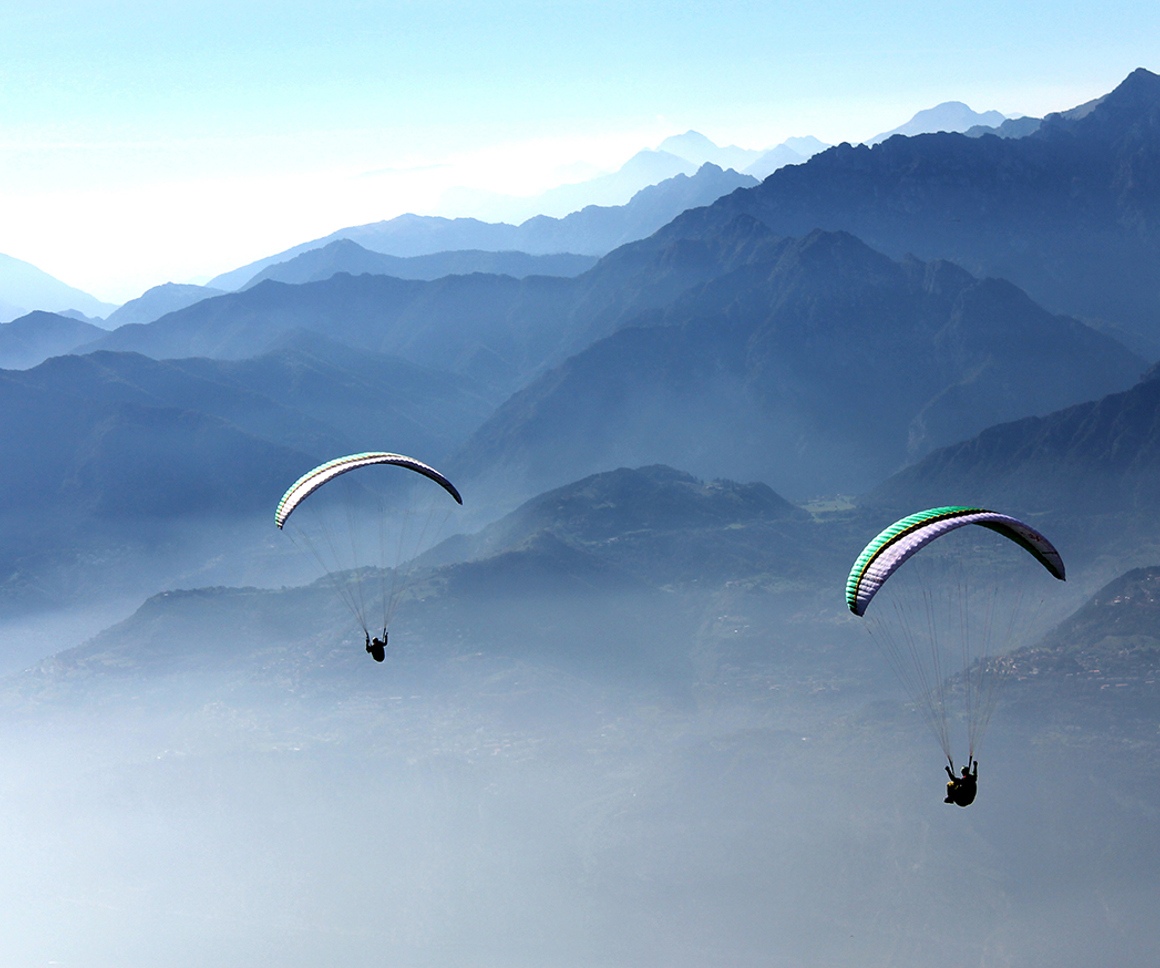 Hangliders over misty vally
