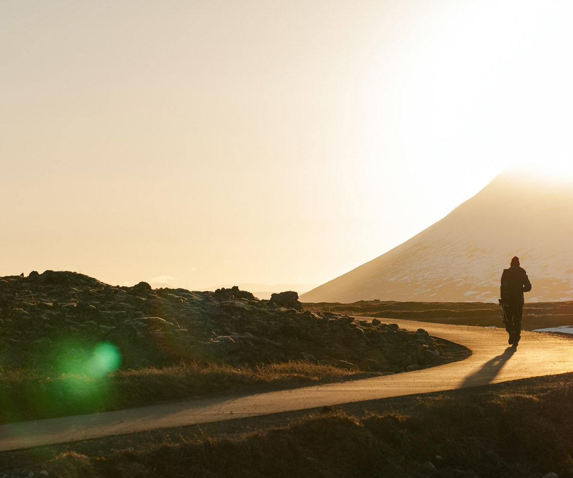 Man walking along winding road