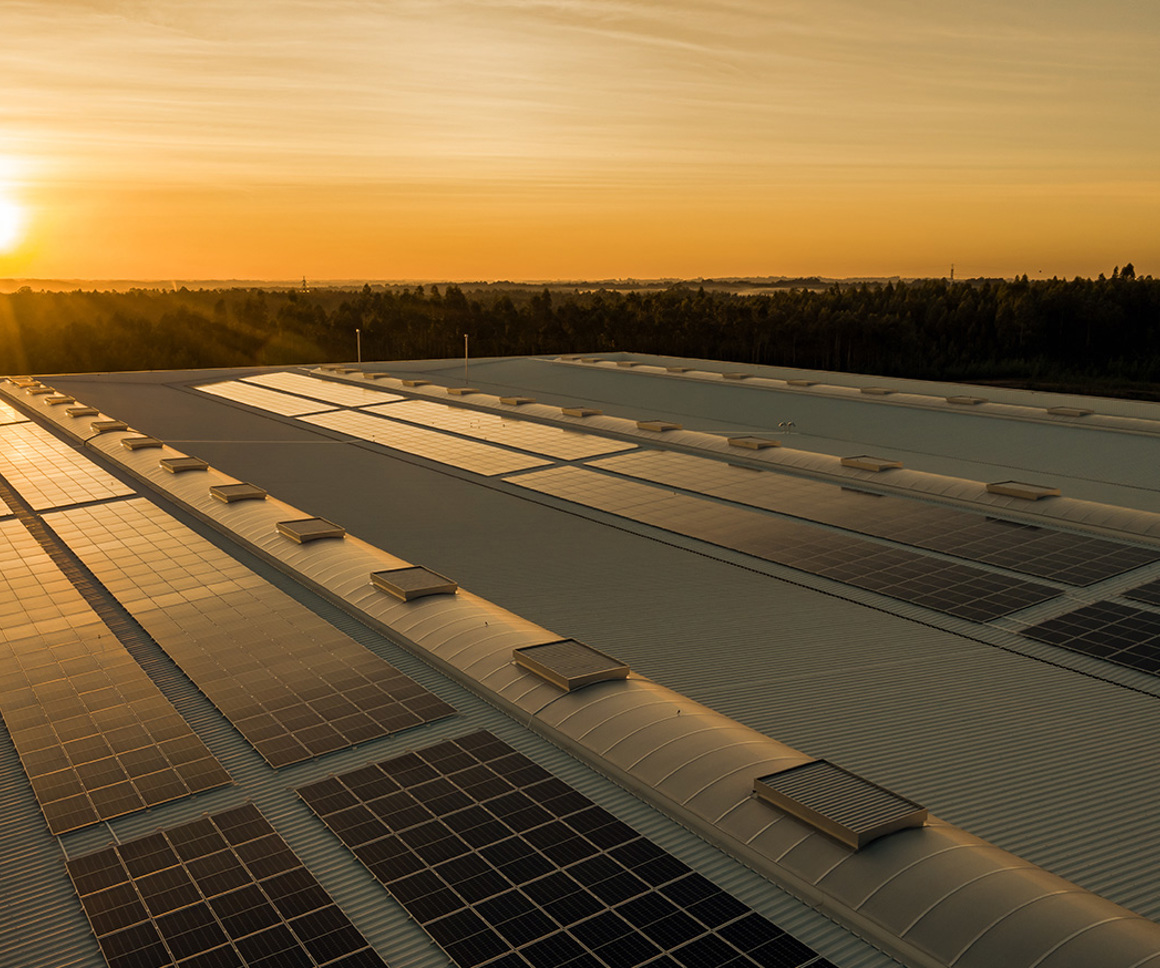 Solar energy panels on a roof at sunset