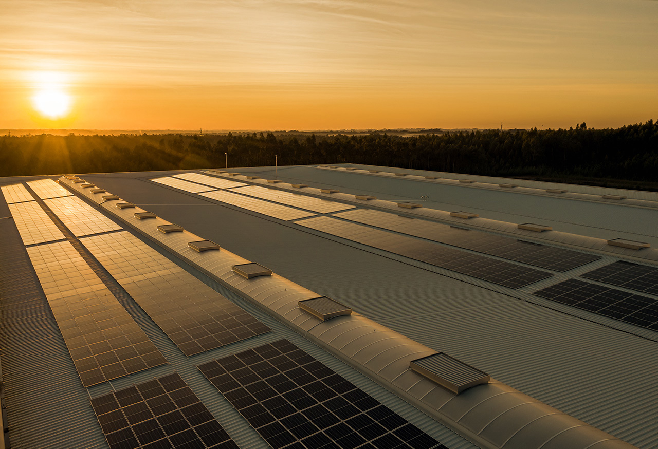 Solar energy panels on a roof at sunset